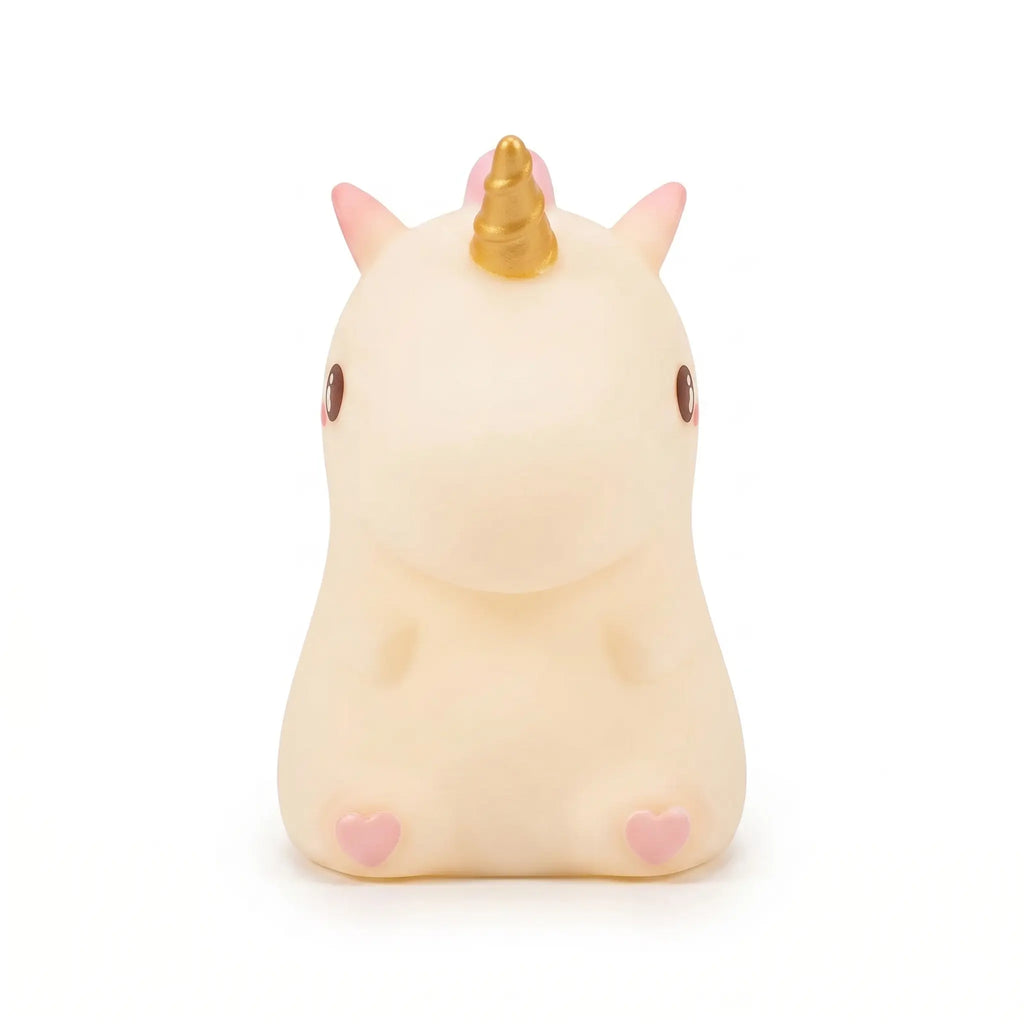 Petite veilleuse licorne en silicone blanc et rose avec une corne dorée, idéale pour la chambre d'enfant.