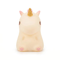 Petite veilleuse licorne en silicone blanc et rose avec une corne dorée, idéale pour la chambre d'enfant.
