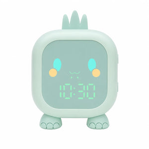 Réveil veilleuse dinosaure de couleur verte vu de face avec son affichage numérique lumineux sur fond blanc.