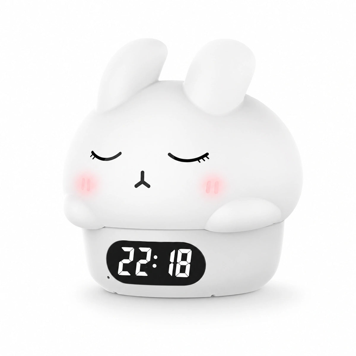 Réveil veilleuse lapin blanc en vue de trois-quarts mettant en avant sa forme arrondie en silicone sur fond blanc.