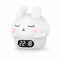 Réveil veilleuse lapin blanc en vue de trois-quarts mettant en avant sa forme arrondie en silicone sur fond blanc.