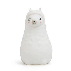 Veilleuse en silicone en forme de petit alpaga blanc sur fond blanc.