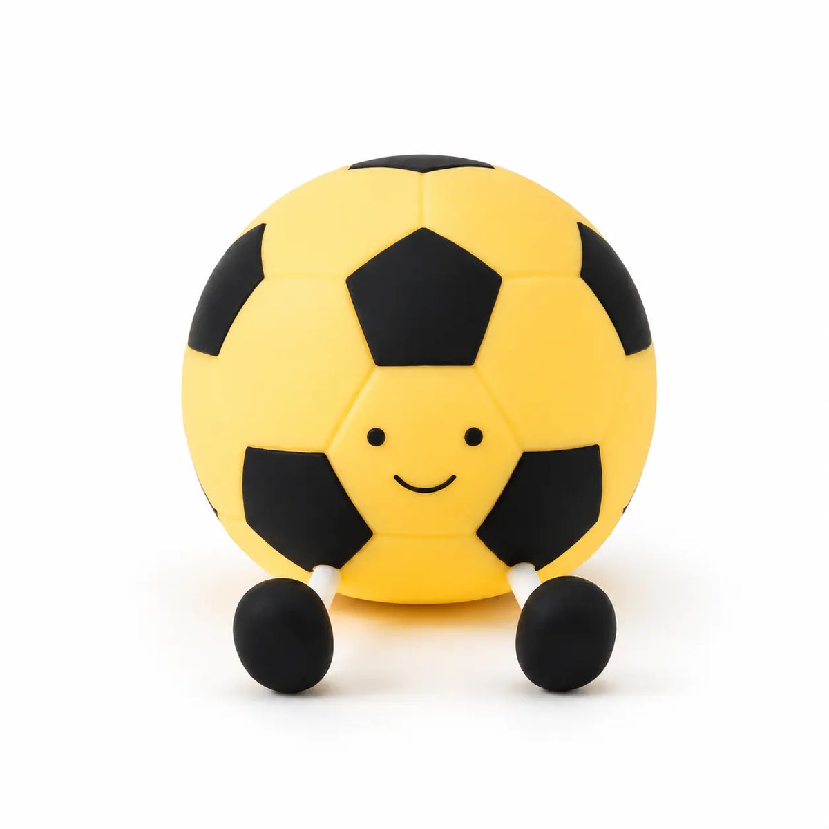 Veilleuse ballon de football jaune en silicone avec visage souriant et petites jambes noires sur fond blanc