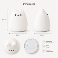 Infographie présentant les dimensions d'une veilleuse chat en silicone (90 x 89 x 102 mm) et son poids (145 g). Le visuel montre le produit éteint sous quatre angles différents (face, profil, dessus, dessous) sur un fond blanc épuré.