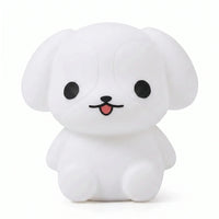 Veilleuse en silicone en forme de petit chiot blanc sur fond blanc.