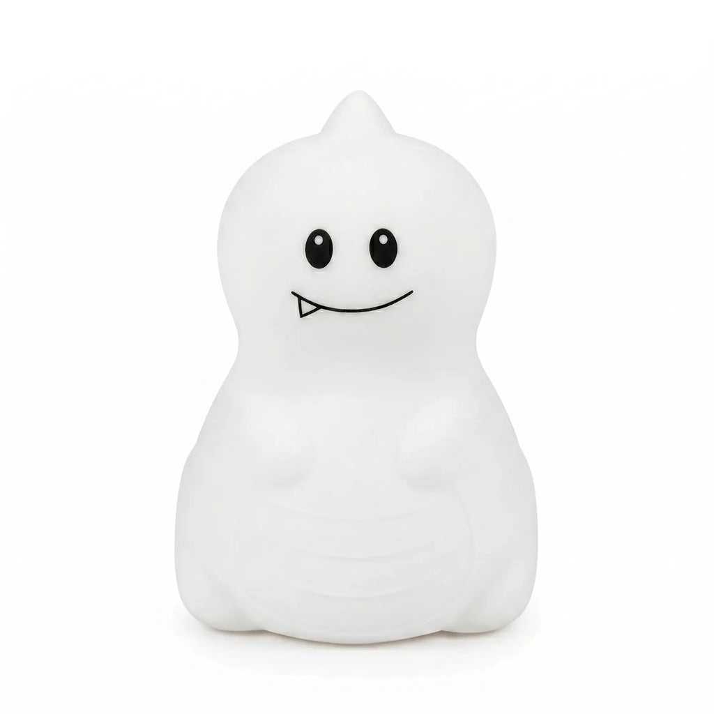 Veilleuse en silicone en forme de petit dinosaure blanc avec une petite dent, sur un fond blanc.