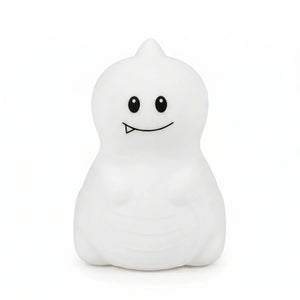 Veilleuse en silicone en forme de petit dinosaure blanc avec une petite dent, sur un fond blanc.