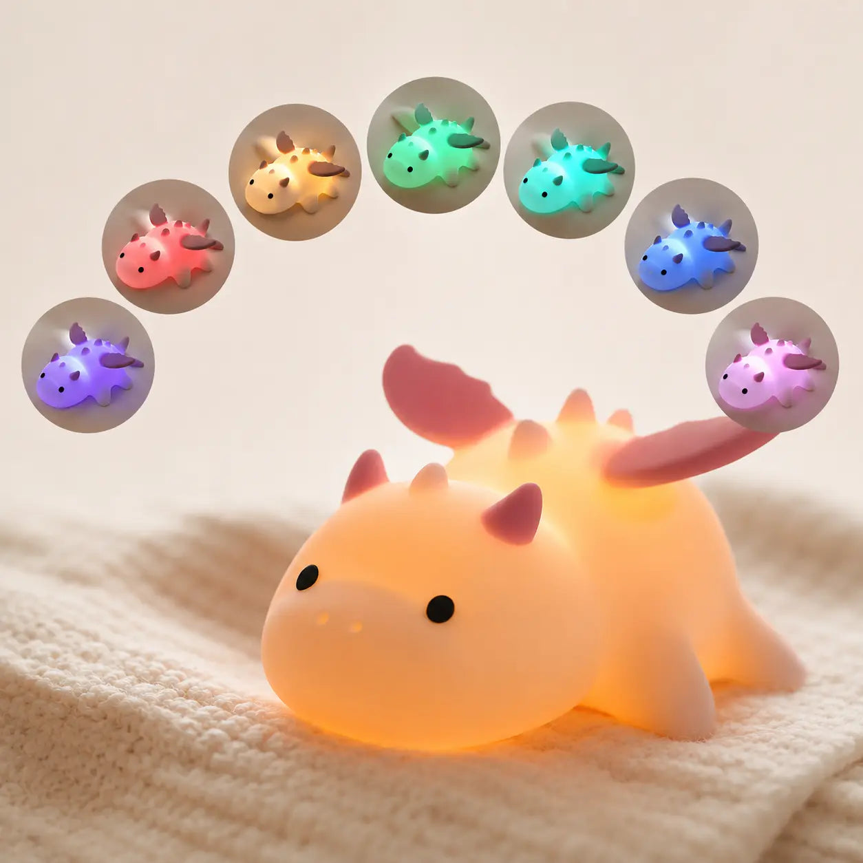Veilleuse dragon en silicone illuminée affichant en arc de cercle les différentes variations de couleurs LED disponibles