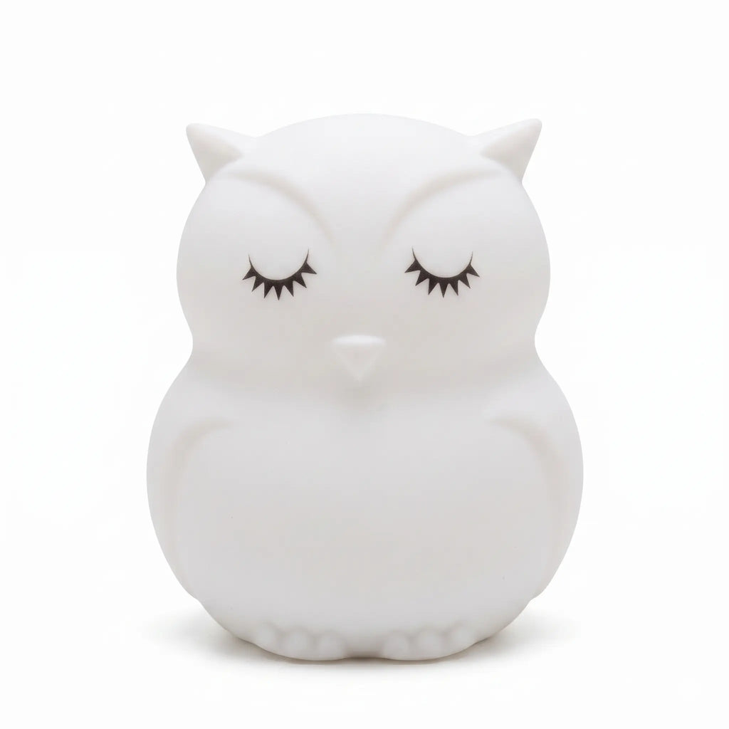 Veilleuse en silicone en forme de petit hibou blanc aux yeux fermés, sur un fond blanc.