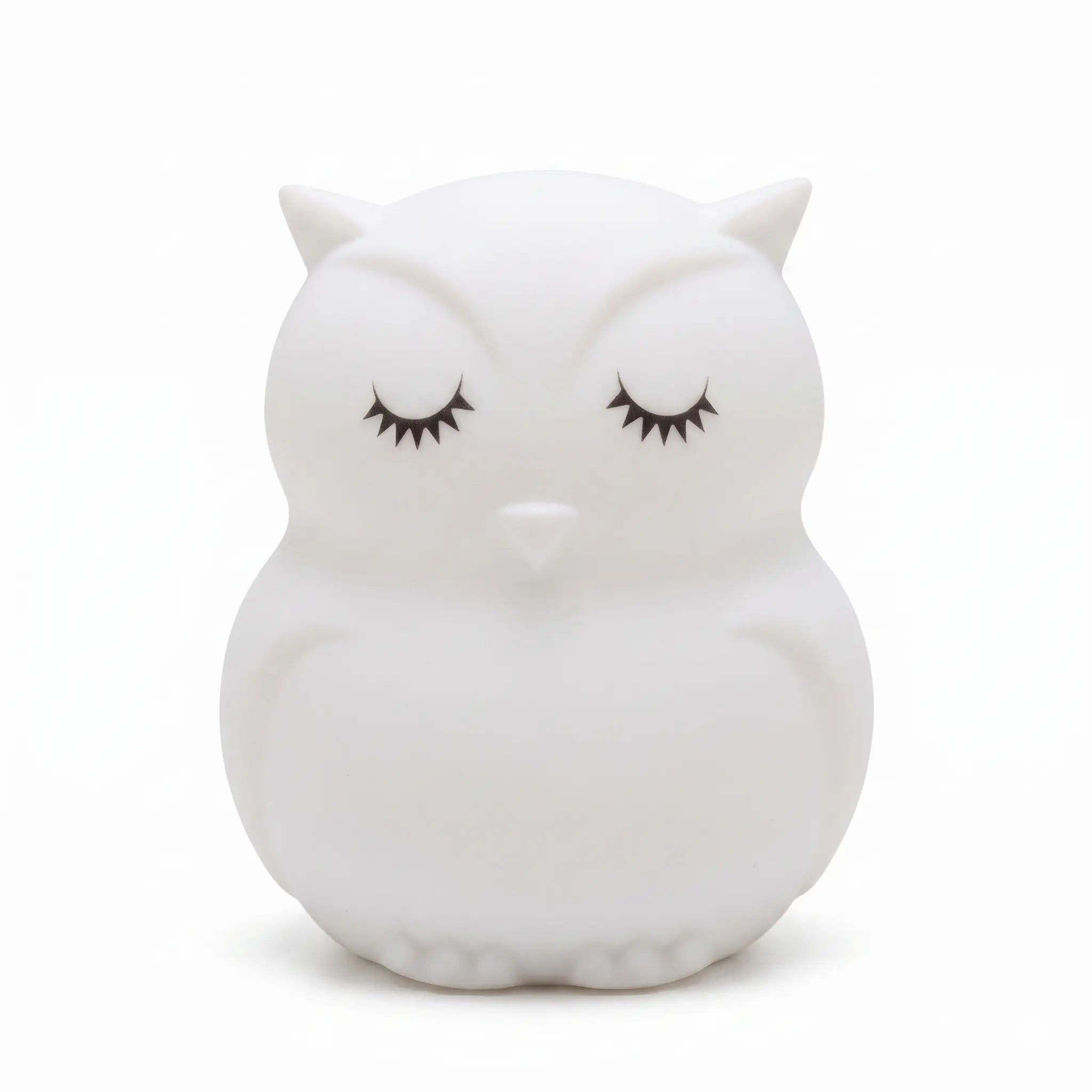 Veilleuse en silicone en forme de petit hibou blanc aux yeux fermés, sur un fond blanc.