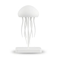 Veilleuse blanche en silicone en forme de méduse au design minimaliste et épuré, surélevée sur une tige centrale fixée à une base rectangulaire, présentée éteinte sur fond blanc.