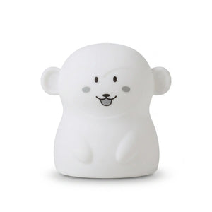 Veilleuse en silicone en forme de petit singe blanc, sur un fond blanc.
